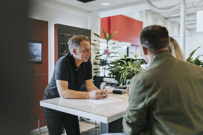 Salesman talking with customers