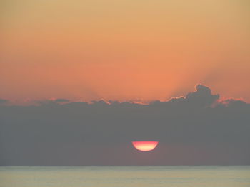 Scenic view of sea against romantic sky at sunset