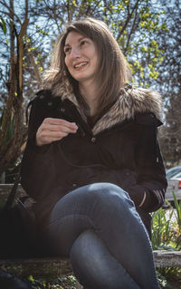 Portrait of a young woman sitting outdoors