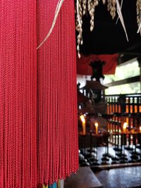 Close-up of illuminated christmas lights in building during winter