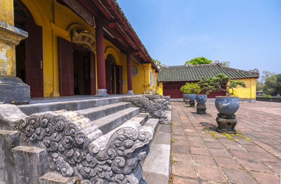 Exterior of houses by building against sky