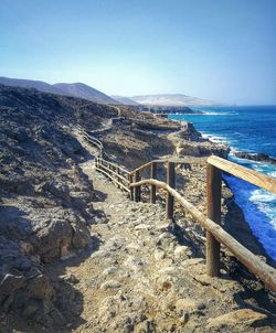 Scenic view of sea and mountains against clear blue sky fuerteventura