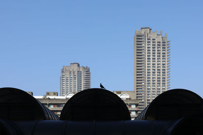 Modern buildings against clear blue sky