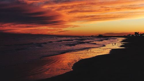 Scenic view of beach against sky during sunset