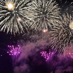 Low angle view of firework display at night