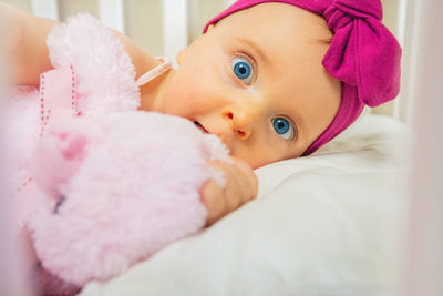 Portrait of cute baby boy sleeping on bed at home