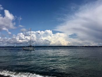 Sailboat sailing in sea against sky