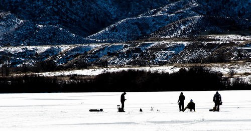 People on snow covered field