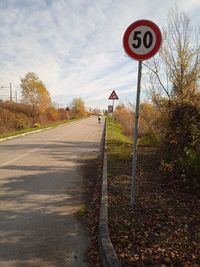 Road sign against sky