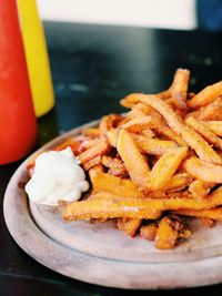 Close-up of sweet potatoes fries in plate on field