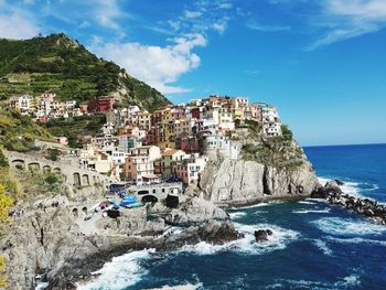 Panoramic view of sea and buildings against sky