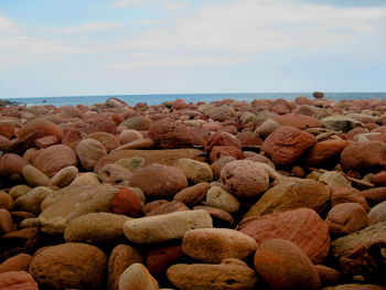 Rocks on beach against sky