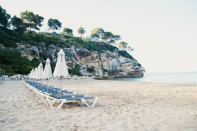 Scenic view to a chaise lounges and umbrellas on the sandy beach