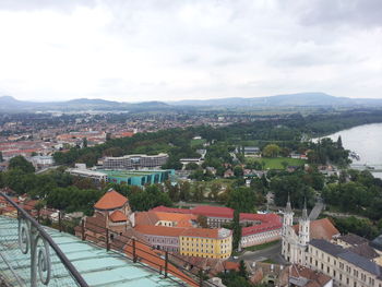 View of cityscape against cloudy sky