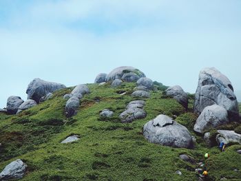 Rocks on landscape against sky