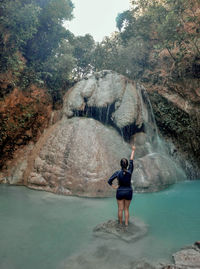 Rear view of man standing in water