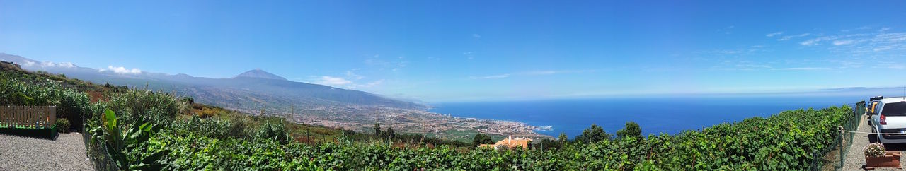 Panoramic view of mountains against blue sky