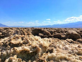 Scenic view of desert against blue sky