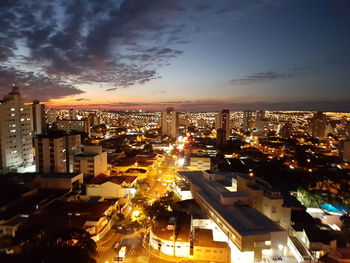 High angle view of illuminated buildings against sky during sunset