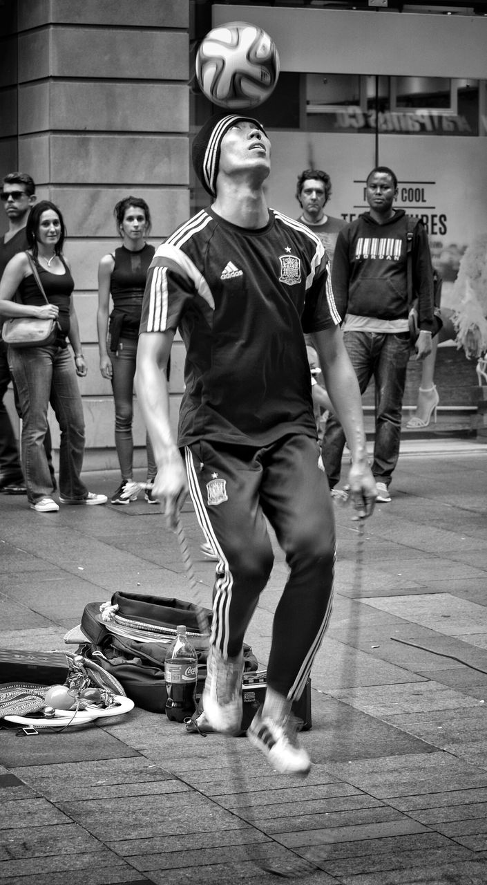 lifestyles, leisure activity, full length, men, casual clothing, person, street, large group of people, togetherness, walking, standing, front view, city life, motion, boys, skill, young men