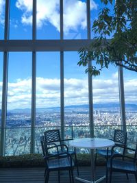 View of cityscape against cloudy sky
