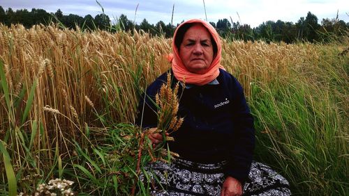 Portrait of smiling man standing in field