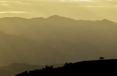 Scenic view of silhouette mountains against sky during sunset