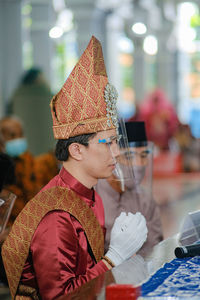 Full length portrait of boy wearing hat on table