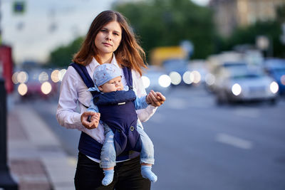 Full length of mother and daughter in city