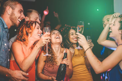 Group of young people drinking glasses at night