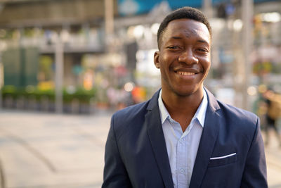 Portrait of smiling young man in city