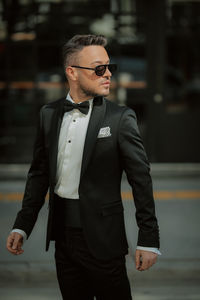 Young man wearing sunglasses standing outdoors