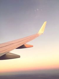 Airplane wing against sky