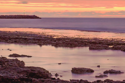 Scenic view of sea against sky at sunset