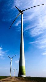 Low angle view of windmill on field against sky