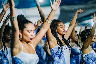 Group of people dancing at music concert