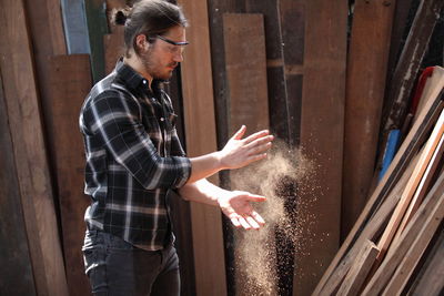 Carpenter cleaning hands in workshop