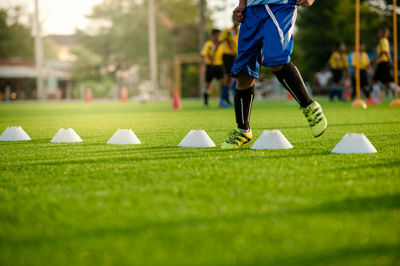 Low section of man exercising on field