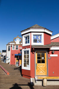 Multi colored built structure against clear blue sky