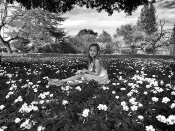 Portrait of girl standing on field in park