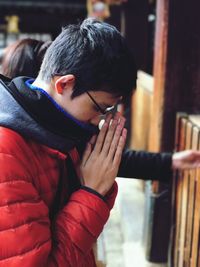 Close-up of man praying at temple