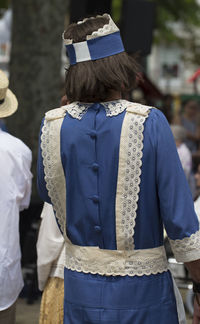 Rear view of people standing outdoors