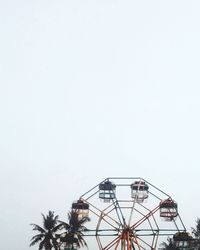 Low angle view of ferris wheel against clear sky