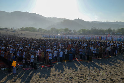 Group of people on land against sky