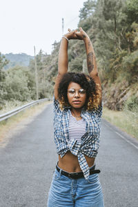 Girl enjoying outdoors with arms aloft