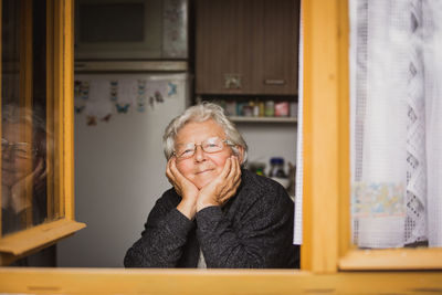 Portrait of young woman sitting at home