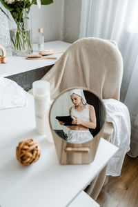 Beauty blogger, vlogger, influencer. young woman in pajamas, towel on her head and with cosmetic