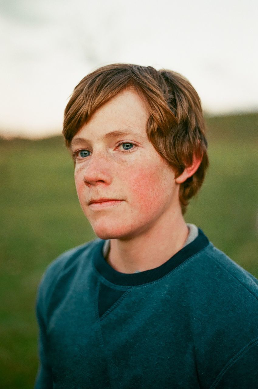 portrait, headshot, focus on foreground, one person, casual clothing, real people, leisure activity, lifestyles, boys, looking at camera, males, men, close-up, day, young adult, front view, nature, young men, teenage boys, teenager, contemplation, adolescence, hairstyle