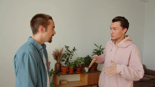 Side view of couple standing at home