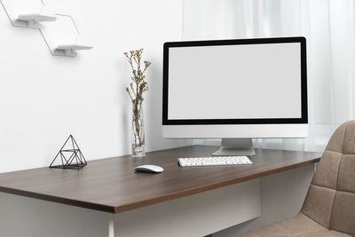 Computer on table against white background